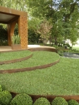 Sinuous curves of cor-ten steel edged lawn sweep across Paal Grant's 'Conversation' garden