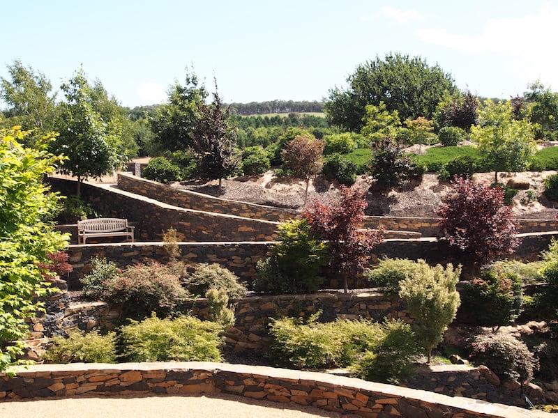 Massive stone walls and wide paths dominate the Mayfield Water Garden