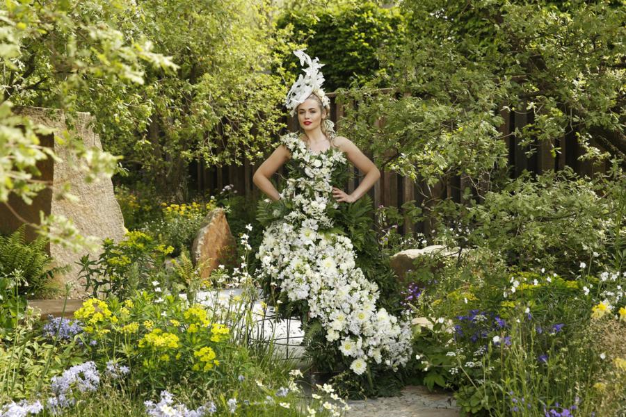 A model poses in a dress of flowers and foliage designed by Cleve West in the M&G garden at the RHS Chelsea Flower Show 2016 in London, UK Monday May 23, 2016. RHS / Luke MacGregor